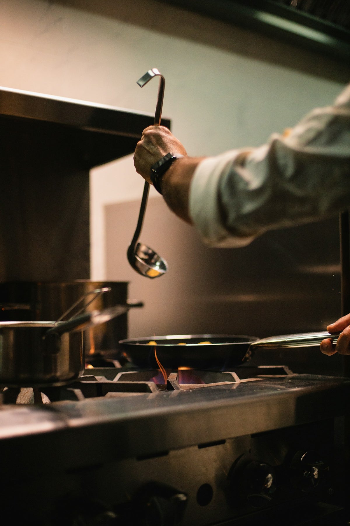 A hand holding a stainless steel spoon