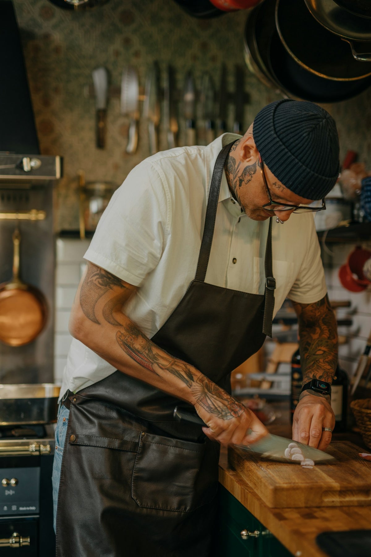A cook holding a kitchen knife